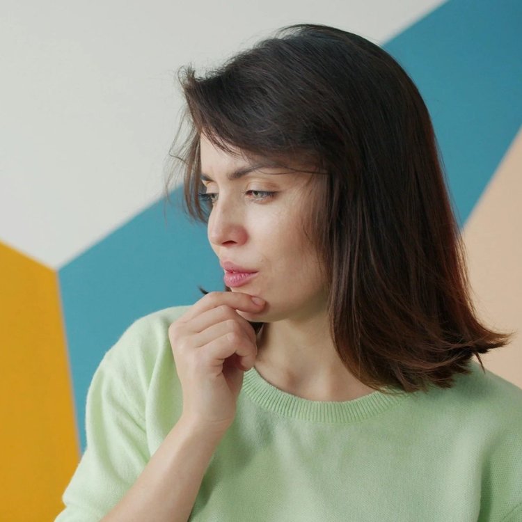 Woman thinking about pregnancy symptoms